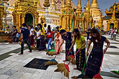 Yangon Myanmar. Shwedagon Pagoda (the Golden Stupa). Some fervent believers sweep some square meters of the pagoda, and symbolically washing their sins.